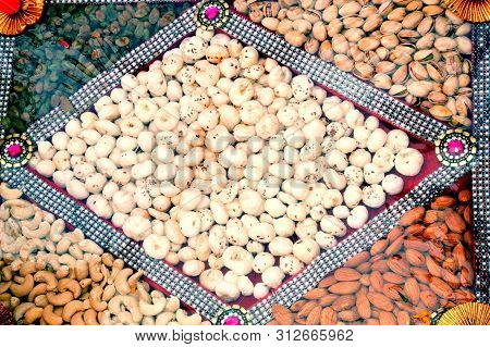 Assortment Of Tasty Nuts, Close Up, In The Box Of Paper And Polythene
