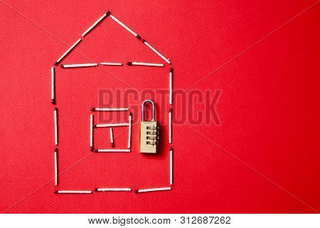 Fire Safety, Or Security And Protection Concept. A Fire Extinguisher, The Figure Of The House And Lo