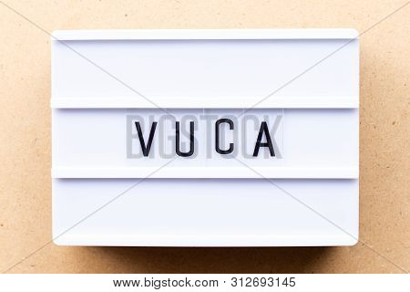 Lightbox With Word Vuca (abbreviation Of Volatility, Uncertainty, Complexity And Ambiguity) On Wood 