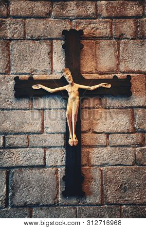 Jesus statue on wall. Romanesque monastery in village in Pueblo Espanol Barcelona, Spain