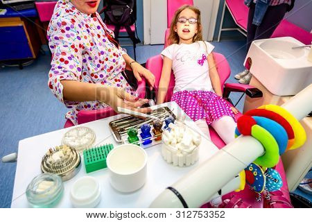Set Of Dentist Tools And Equipment On Clinic Desktop