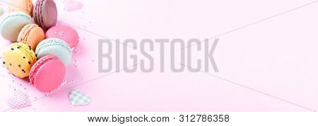 Colorful French Macarons On Pink Background With Copy Space, Traditioanal Dessert In France