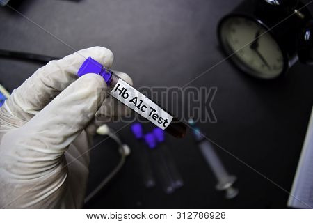 Hb A1c Test Text With Blood Sample. Top View Isolated On Black Background. Healthcare/medical Concep