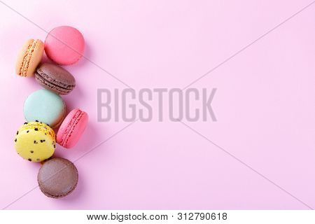 Colorful French Macarons On Pink Background With Copy Space, Traditioanal Dessert In France