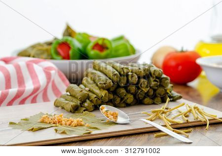 Traditional Turkish Food. Grape Leaves Are Filling With Spices And Rice.the Stuffed Peppers Are In T