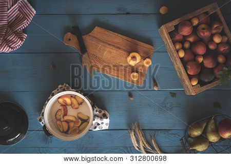 Kitchen Table And The Making Of Fruit Jam. Flat Lay With A Box Of Peaches And Apricots, Slicing Frui