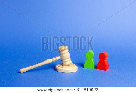 Two Figures Of People Opponents Stand Near The Judge's Gavel. The Judicial System. Conflict Resoluti