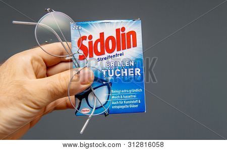 Paris, France - Jul 14 2019: Man Hand Holding Sidolin Henkel Special Towels To Clean The Eyeglasses,