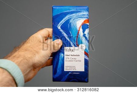 Paris, France - Jul 14 2019: Man Hand Holding Delicious Viviani Edel Vollmilch With 37 Cacao From Ec