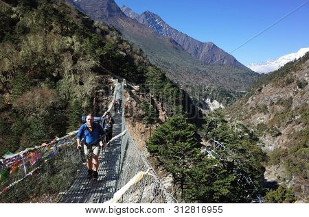 Sagarmatha national park, Nepal - May 17, 2019: Tourists on suspension bridge. Everest trek, trail between Deboche and Tengboche
