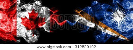 Canada Vs Marshall Islands Smoky Mystic Flags Placed Side By Side. Thick Colored Silky Smoke Flags O