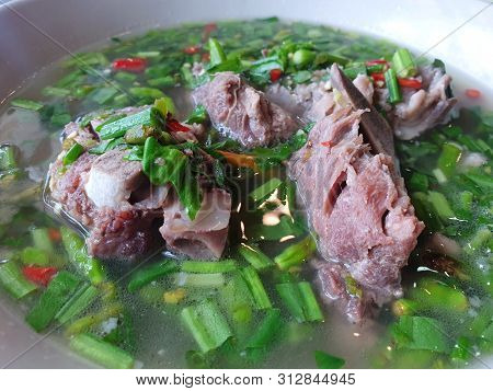 Thai Food Style, Selective Focus Of Hot And Spicy Pork Neck Bones Soup In White Bowl As A Background