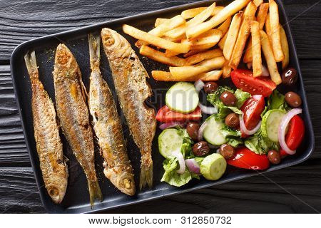 Fried Mediterranean Boops Boops Fish Served With Fresh Salad And French Fries Close-up On A Plate. H