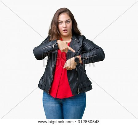 Beautiful plus size young woman wearing a fashion leather jacket over isolated background In hurry pointing to watch time, impatience, upset and angry for deadline delay