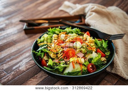 Salad made from radiatori cooked pasta, goat cheese and oil vinaigrette