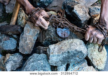 The Hands Of A Slave In An Attempt To Release. The Symbol Of Slave Labor. Hands In Chains.