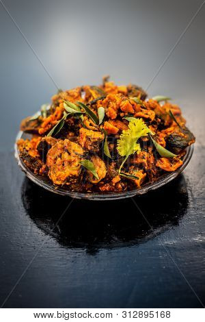 Famous Indian & Gujarati Snack Dish In A Glass Plate On Wooden Surface I.e. Patra Or Paatra Consisti