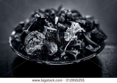 Famous Indian & Gujarati Snack Dish In A Glass Plate On Wooden Surface I.e. Patra Or Paatra Consisti