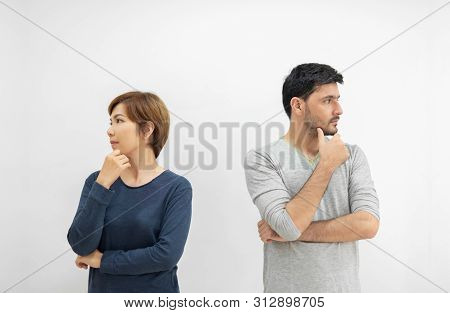 Portrait Of Young Couple Standing Separately With Arms Crossed And Thinking Something On White Isola