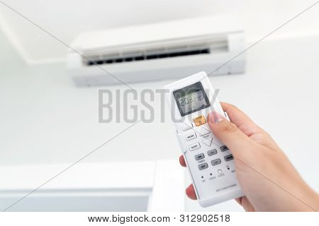 Adjusting Temperature Of Air Conditioner By Remote. Air Conditioning System