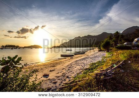 Beautiful Sunset At Teluk Kok Langkawi. Sandy Beach With Boats.
