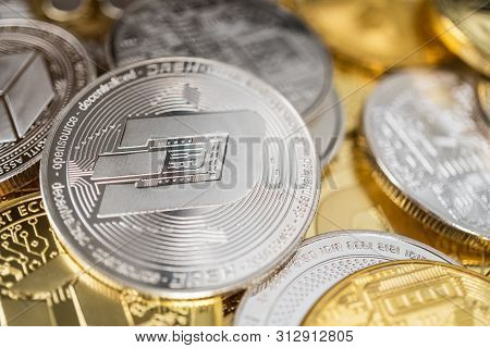 Dash Physical Coin On The Stack Of Other Different Cryptocurrencies. Close-up Photo Of Dash With Sha