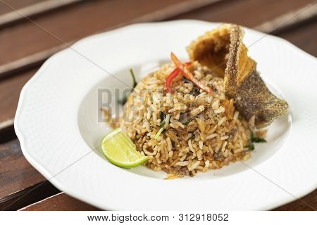 Healthy Thai Food Which Called Kaw Pad Pra Salid Of Fried Rice With Crispy Snakeskin Gourami Fish.
