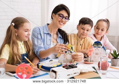 Modern Technology. Kids Creating Robots With Teacher At Stem Education Class