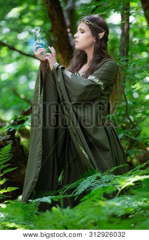 Elf With A Bottle Of Magic Potion In The Forest