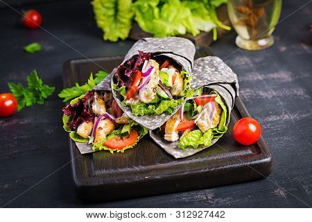 Tortilla With Added Ink Cuttlefish Wraps With Chicken And Vegetables On Black Background. Chicken Bu