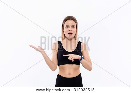 Young Sporty Blond Woman In A Black Sportswear With Smart Watches For Pulse Measuring Pointing With 