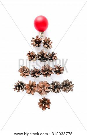 Christmas Composition With Christmas Fir Tree Made Of Pine Cones And Redball On White Background. Fl