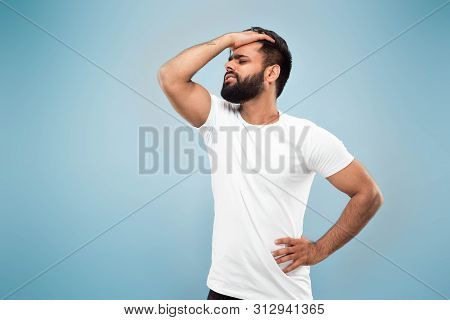 Half-length Close Up Portrait Of Young Hindoo Man In White Shirt Isolated On Blue Background. Human 