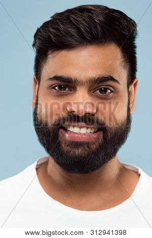 Close Up Portrait Of Young Hindoo Man With Beard In White Shirt Isolated On Blue Background. Human E