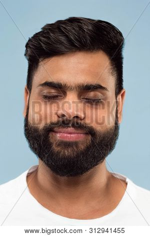 Close Up Portrait Of Young Hindoo Man With Beard In White Shirt Isolated On Blue Background. Human E
