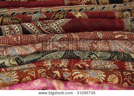 Pile Of Folded Colour Fabrics And Shawls