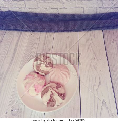 Tasty Marshmallow In A White Plate On A Wooden Table