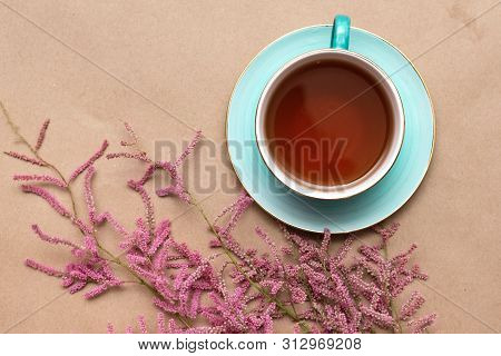 Cup Of Hot Tea And A Tamarix Gallica Tree Branches On A Brown Background.