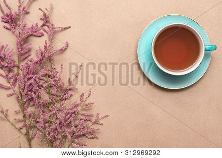 Cup Of Hot Tea And A Tamarix Gallica Tree Branches On A Brown Background.