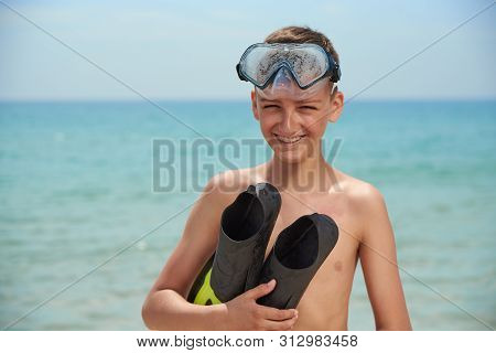 Fun Boy Teenager In A Mask And Panks On The Sea Beach