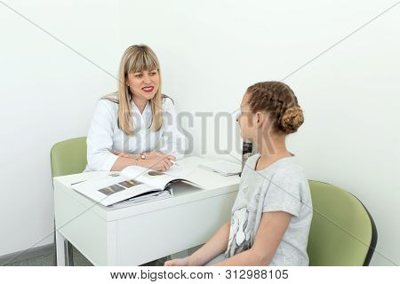 Dnepr / Ukraine - 04.27.2019: Doctor Trichologist Conducts Consultation With A Young Girl Patient.