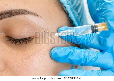 The Beautician Makes Professional Rejuvenation Vitamin Injections For The Skin Of The Patient's Face