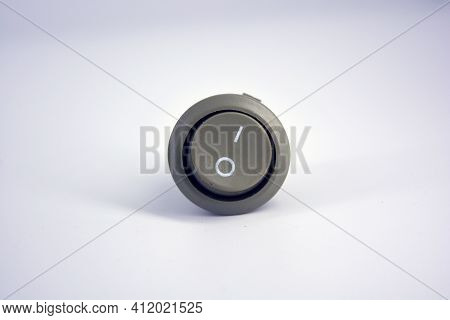 Gray Metal Button With Contacts For Switching And Inclusion Of 220v Or 12v Network Located On A Whit