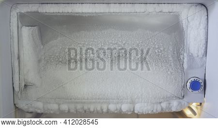 Freezer Of A Refrigerator. Ice Buildup Inside Of A Freezer Walls.