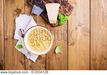 Passatelli In Broth - Pasta Cooked In Chicken Broth. A Pasta Formed Of Bread Crumbs, Eggs, Grated Pa