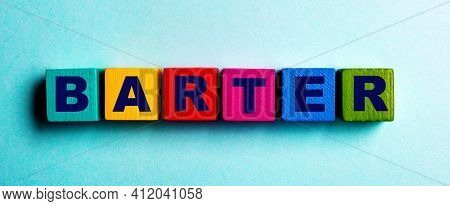 The Word Barter Is Written On Multicolored Bright Wooden Cubes On A Light Blue Background