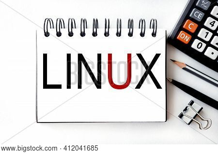 Linux. Text On White Notepad Paper On Light Background.
