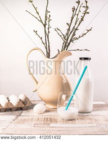 Chicken Eggs In An Egg Box, Ceramic Jug With Willow Branches, A Bottle Of Milk, A Glass Of Milk With