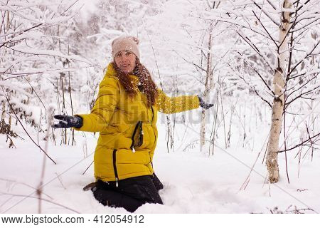 Beautiful Sexy Girl Tosing Snow. Around The Trees In The Snow