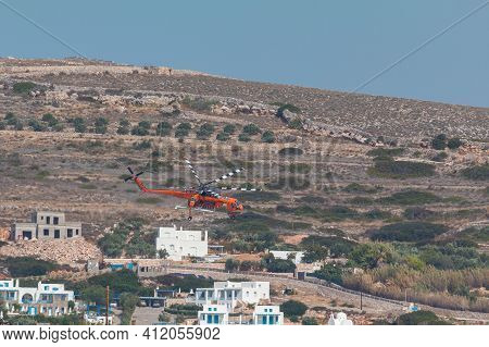 Paros Island, Greece- 26 September 2020: A Helicopter Of The Fire Brigade Extinguishing A Fire Off T